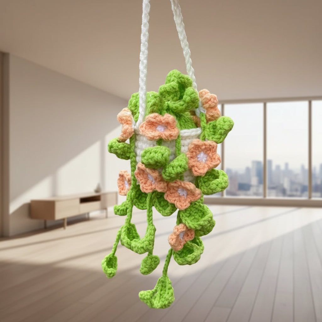 Crocheted flower decoration with 'happy day' text on a wooden floor.