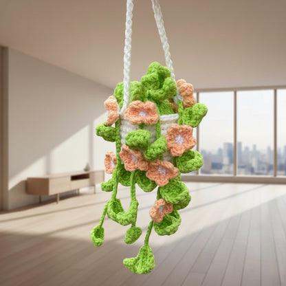 Crocheted flower decoration with 'happy day' text on a wooden floor.