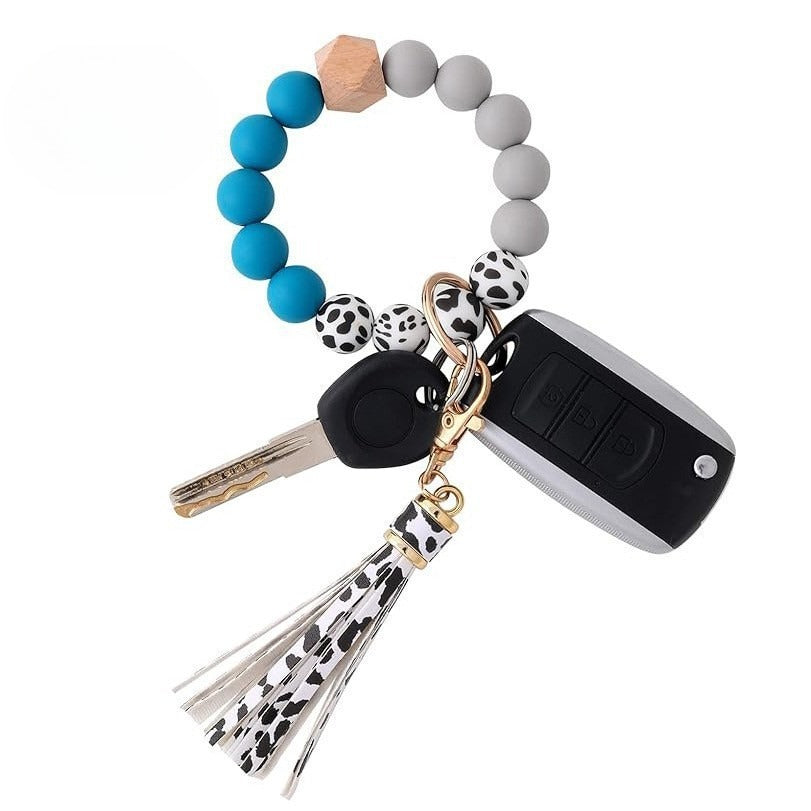 Llavero con borla de PU para bolso de mujer, llavero de silicona con cuentas, pulsera, llavero de coche, bonito soporte para mujeres y niñas. 