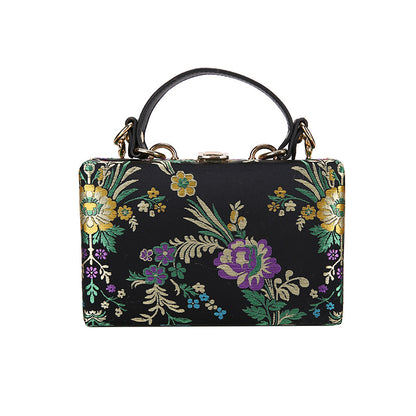 Bolso de mano tipo clutch con estampado floral, ideal para bodas y eventos especiales. Elegante diseño en tonos antiguos. 