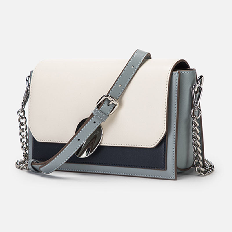 Bolso bandolera pequeño de piel auténtica con múltiples bolsillos y tono contrastante.