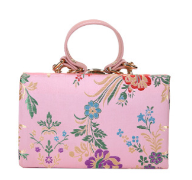 Bolso de mano tipo clutch con estampado floral, ideal para bodas y eventos especiales. Elegante diseño en tonos antiguos. 